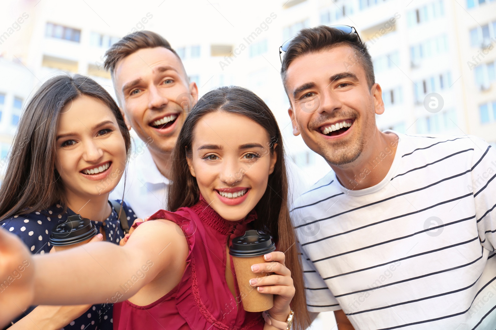 Photo of Group of young people taking selfie outdoors