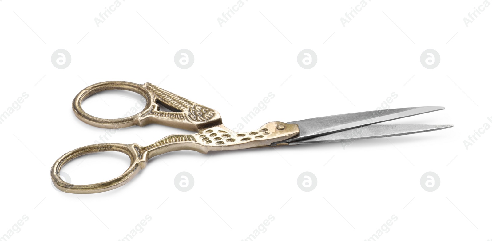 Photo of Pair of scissors with ornate handles isolated on white