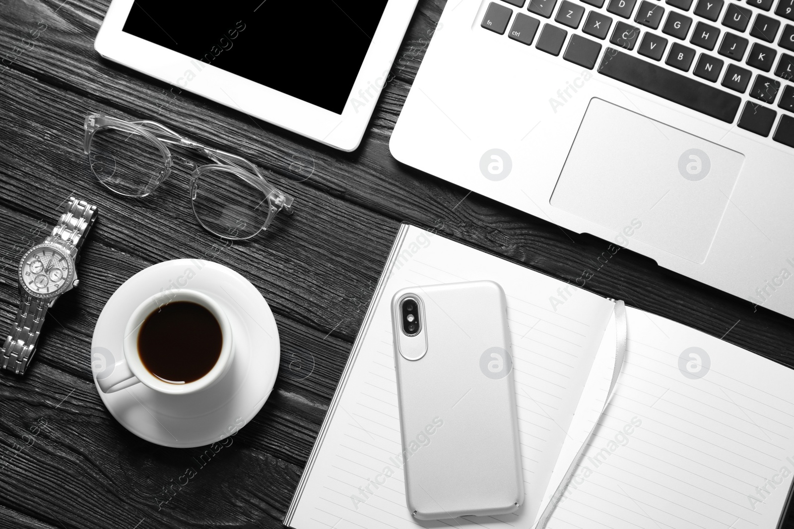 Photo of Flat lay composition with laptop and notebook on wooden table. Blogger's workplace