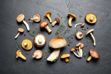 Photo of Flat lay composition with fresh mushrooms, thyme and pepper on grey background