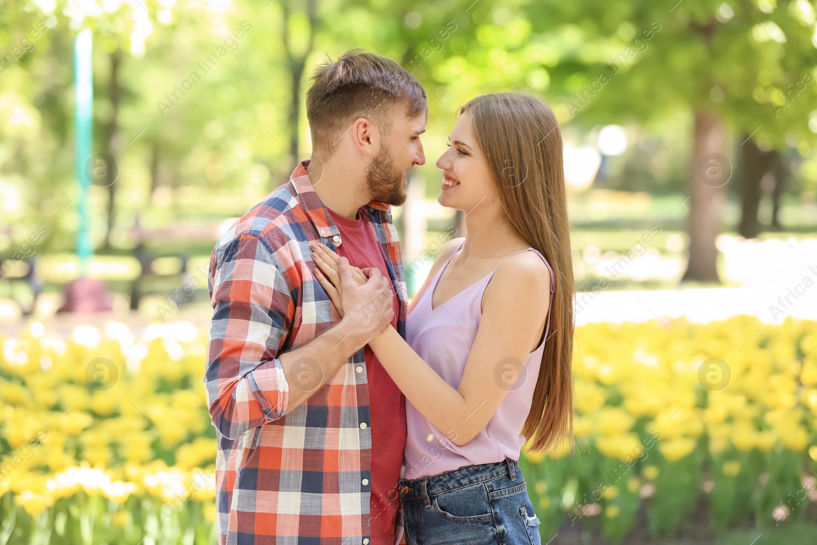 Photo of Happy young couple in green park on sunny spring day