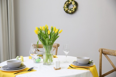 Beautiful Easter table setting with floral decor indoors