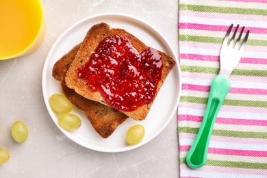 Photo of Flat lay composition with toasts and grapes on light grey marble table. Healthy breakfast