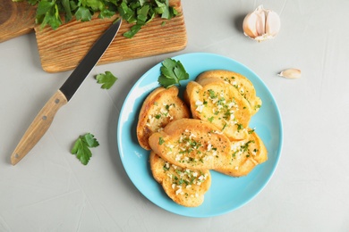 Flat lay composition with tasty homemade garlic bread on table