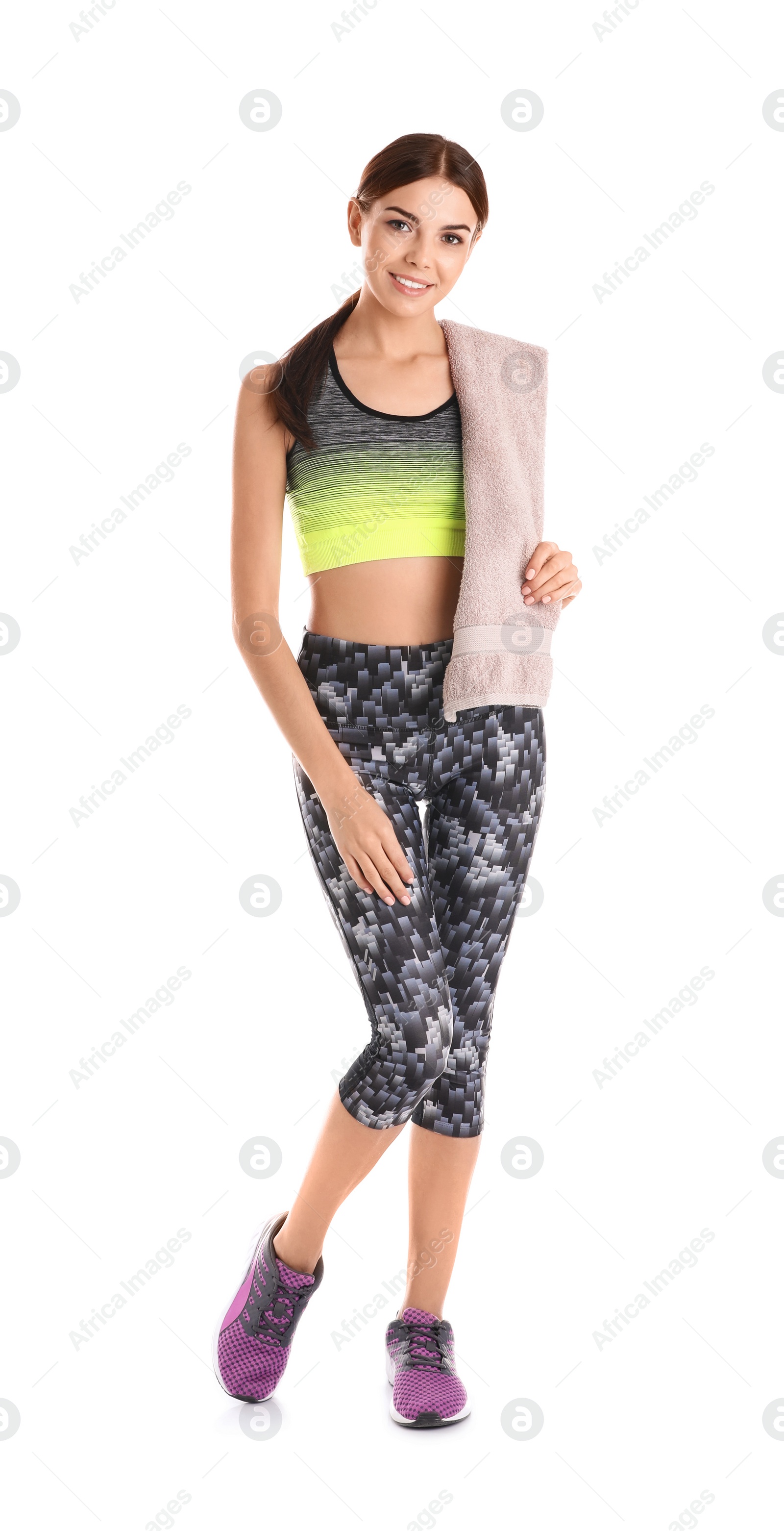 Photo of Beautiful young woman in sportswear with towel on white background