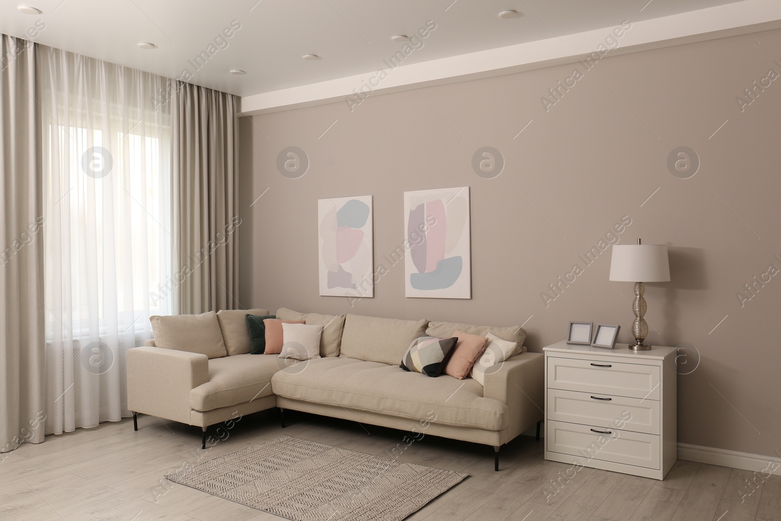 Photo of Stylish living room interior with modern comfortable sofa and pictures