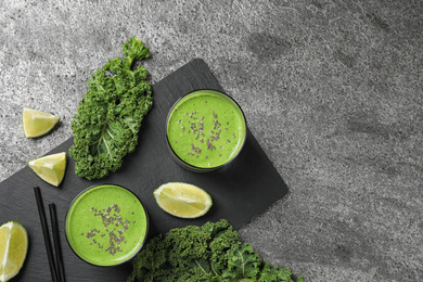 Photo of Flat lay composition with tasty kale smoothie on grey table