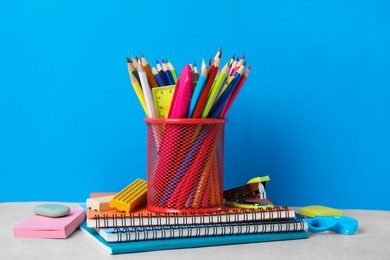 Photo of Different school stationery on table against light blue background. Back to school