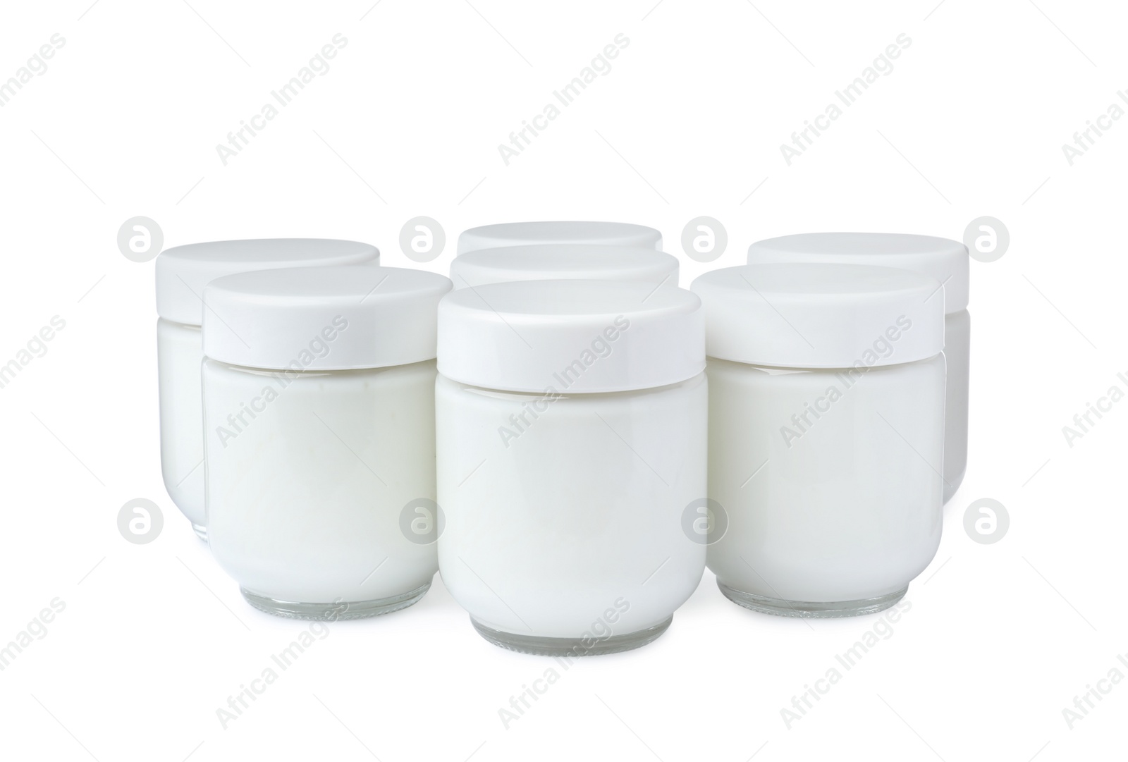 Photo of Glass jars with delicious homemade yogurt on white background