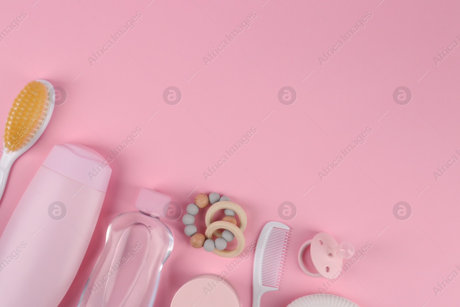 Photo of Flat lay composition with baby care products and accessories on pink background, space for text