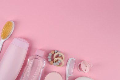 Flat lay composition with baby care products and accessories on pink background, space for text