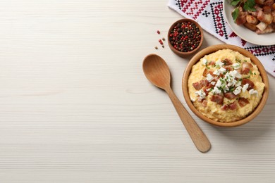 Photo of Delicious traditional Ukrainian banosh served on light wooden table, flat lay. Space for text