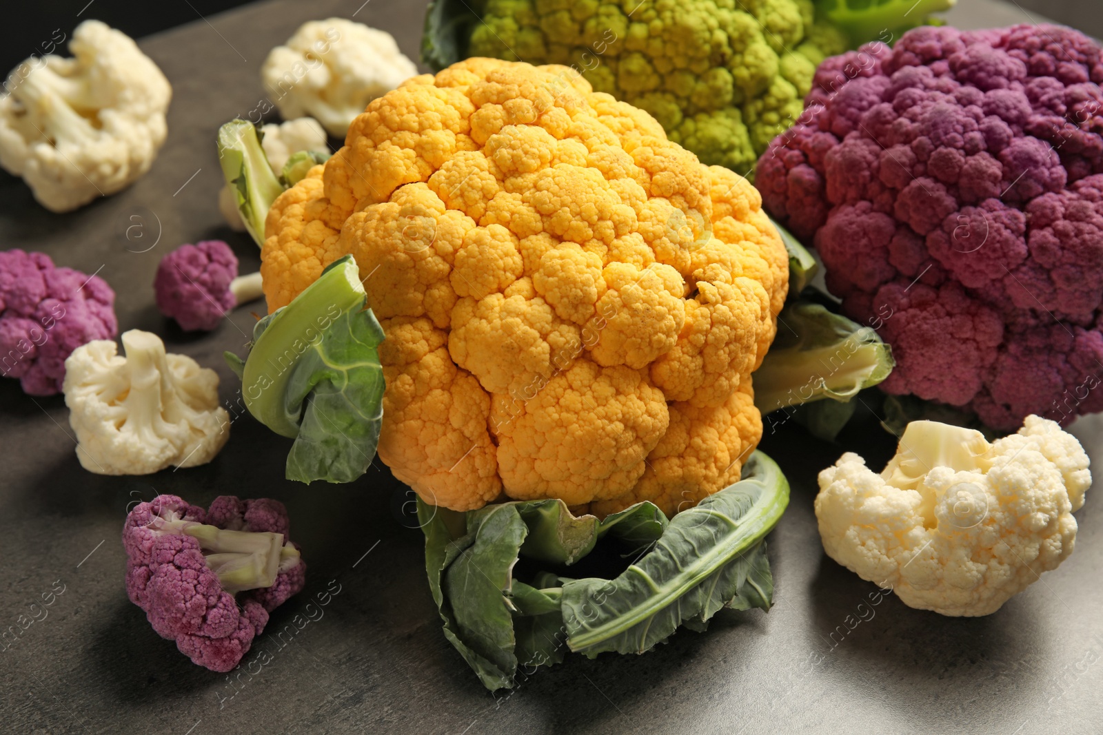 Photo of Colorful cauliflower cabbages on table. Healthy food