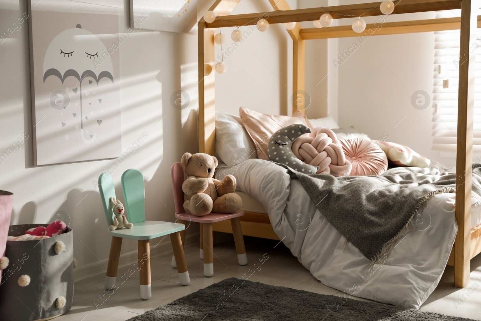 Photo of Cute chairs with bunny ears in children's bedroom interior