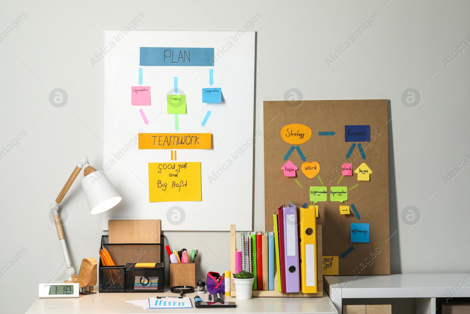 Photo of Business process planning and optimization. Workplace with lamp, colorful paper notes and other stationery on table