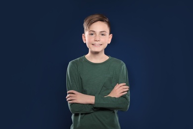 Portrait of little boy on color background