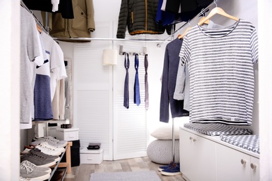 Modern dressing room with different stylish clothes and accessories