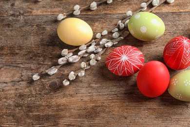 Photo of Flat lay composition with painted Easter eggs on wooden table