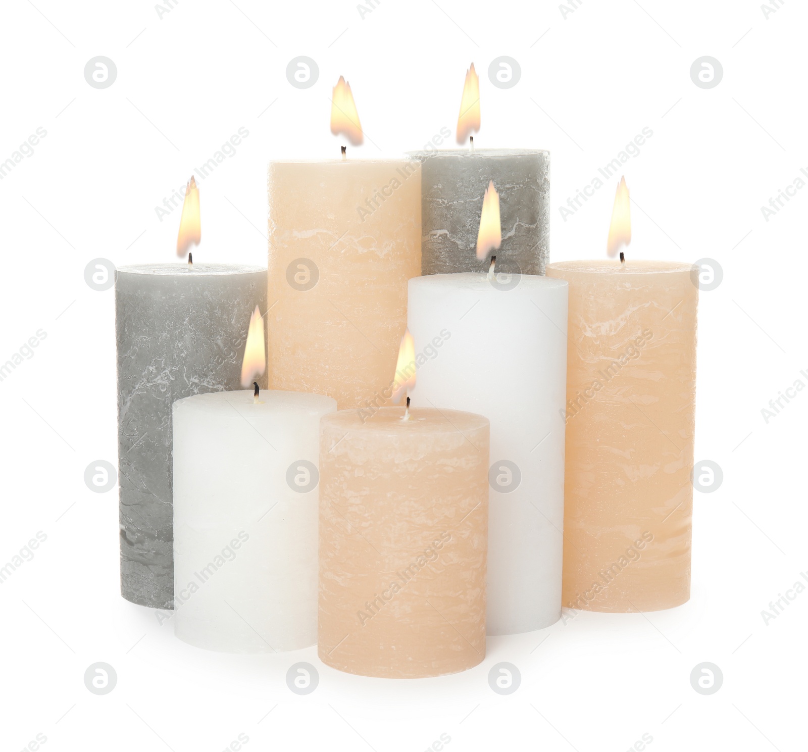 Photo of Many alight wax candles on white background