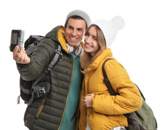 Photo of Couple taking selfie with camera on white background. Winter travel