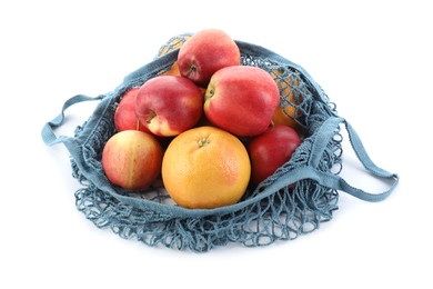 Photo of String bag with apples and orange isolated on white