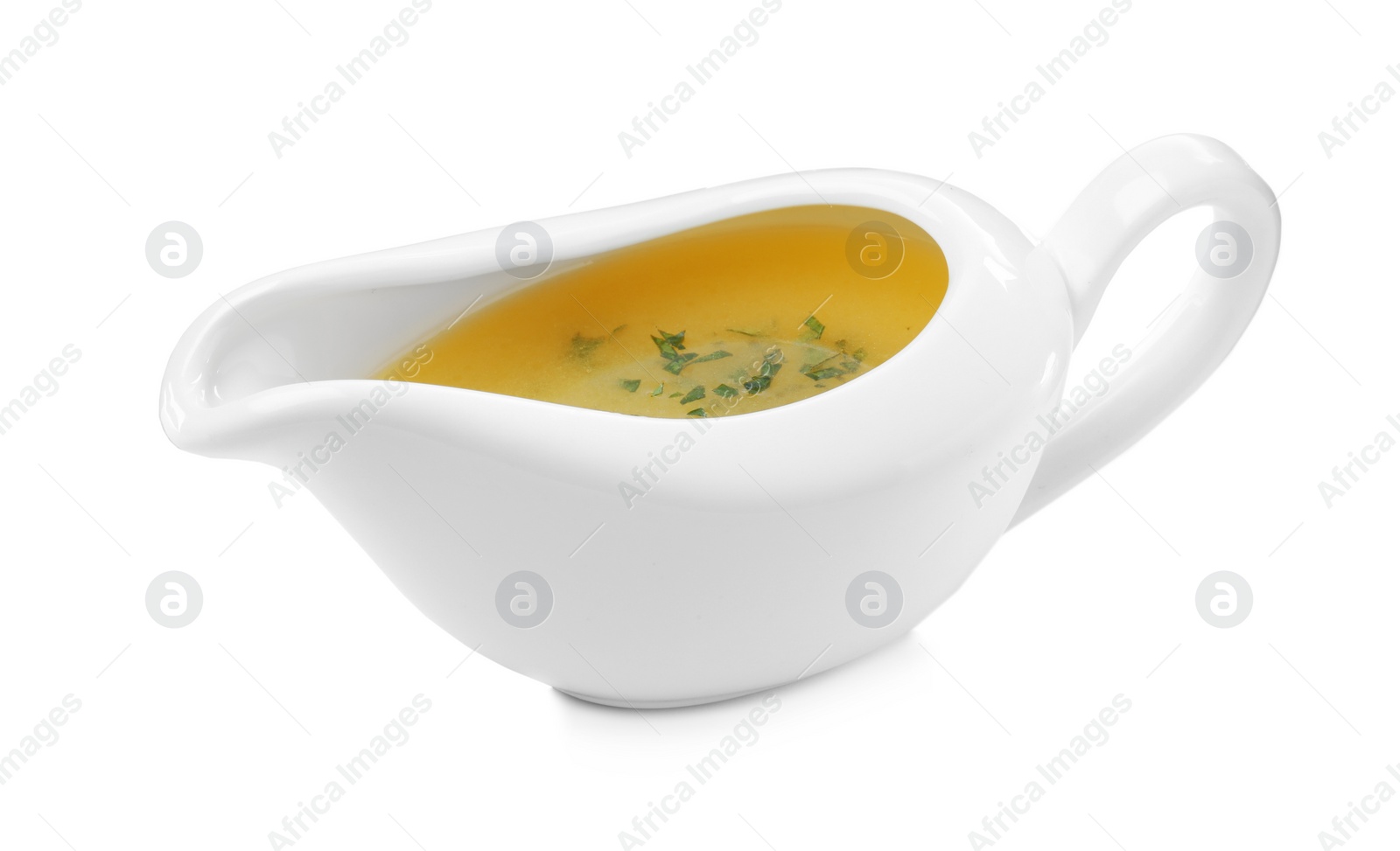 Photo of Ceramic sauce boat with lemon salad dressing on white background