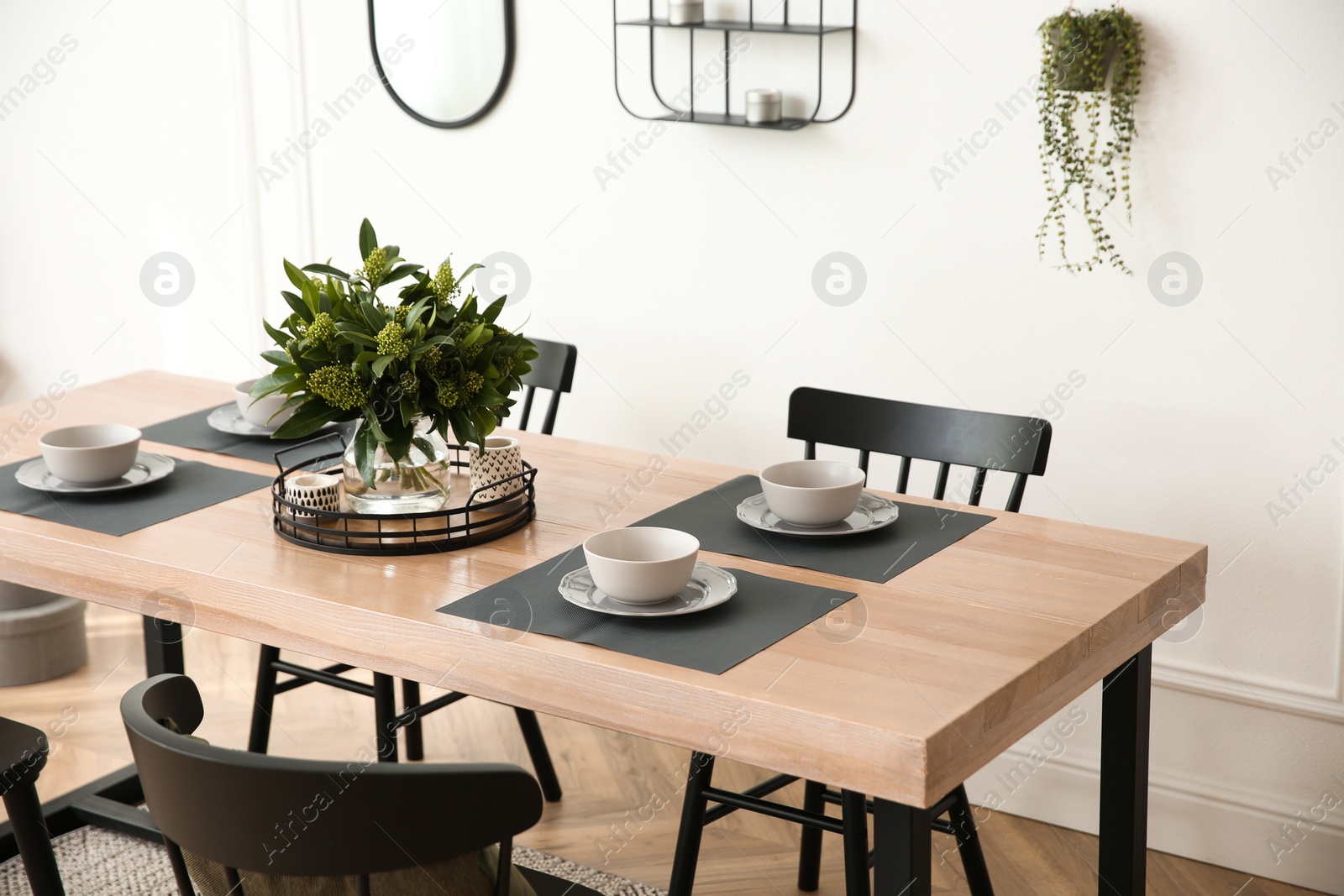 Photo of Stylish wooden dining table and chairs in room. Interior design