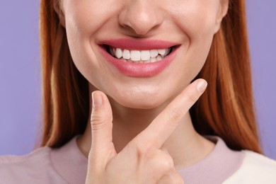 Photo of Woman with clean teeth smiling on violet background, closeup