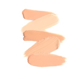 Samples of different foundation shades on white background, top view