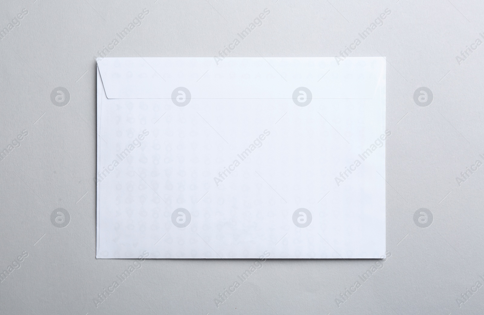 Photo of White paper envelope on light background, top view