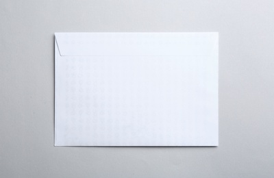 Photo of White paper envelope on light background, top view