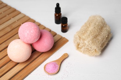 Photo of Beautiful composition with aromatic bath bombs on white wooden table