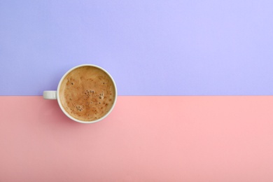 Photo of Cup of coffee on color background, top view. Space for text