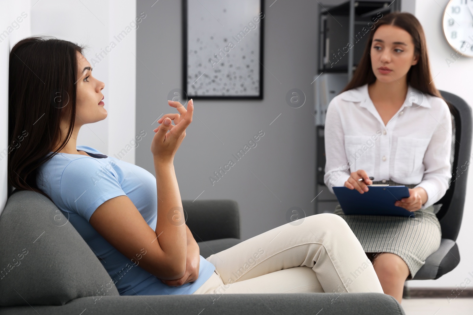 Photo of Professional psychologist working with young woman in office