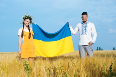 Photo of Friends holding national flag of Ukraine in field