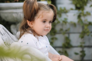 Portrait of cute little girl outdoors, space for text