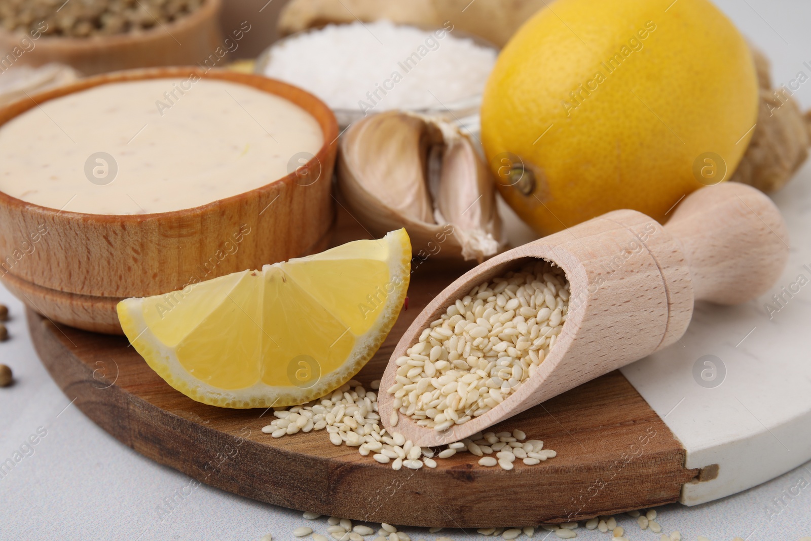 Photo of Fresh marinade and different ingredients on white tiled table, closeup