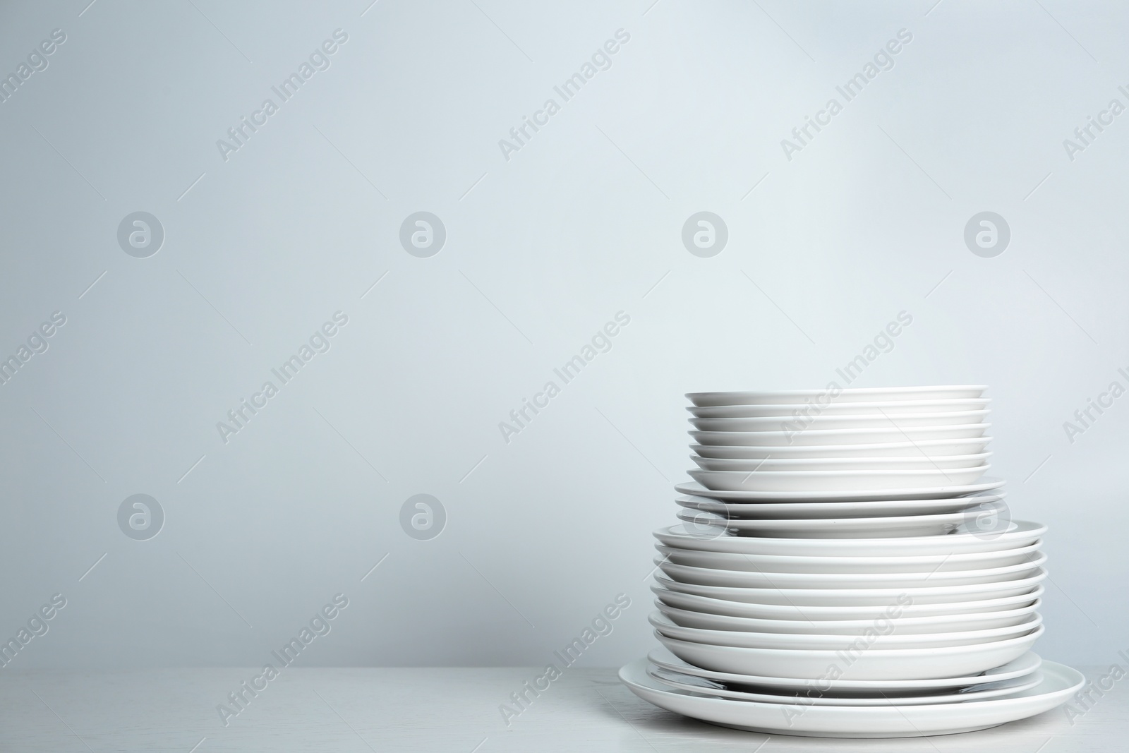 Photo of Stack of clean plates on white background