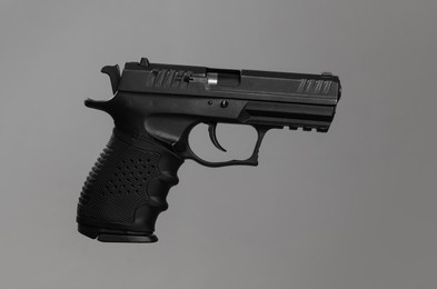 Photo of Standard handgun on light grey background. Semi-automatic pistol