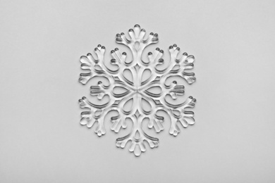 Photo of Beautiful decorative snowflake on light grey background, top view