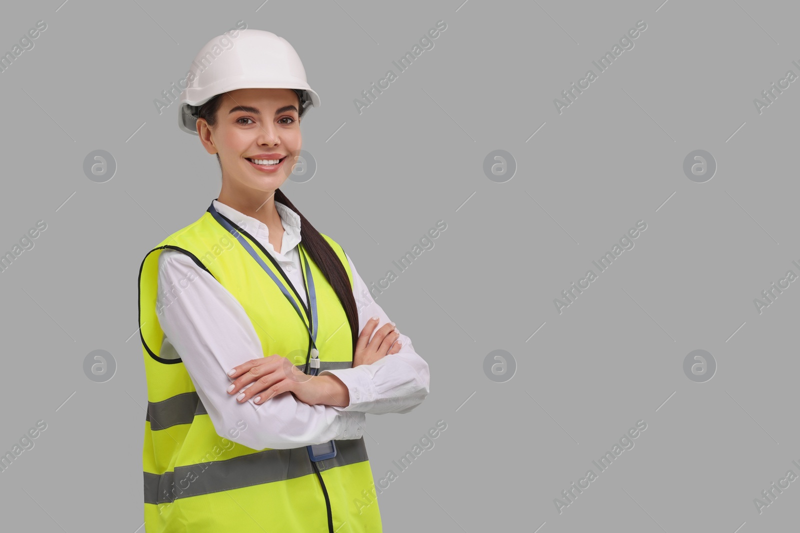 Photo of Engineer with hard hat on grey background, space for text