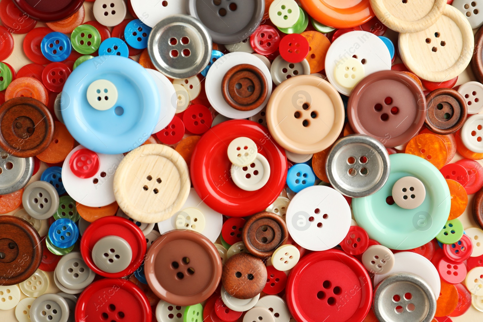 Photo of Many plastic sewing buttons as background, closeup