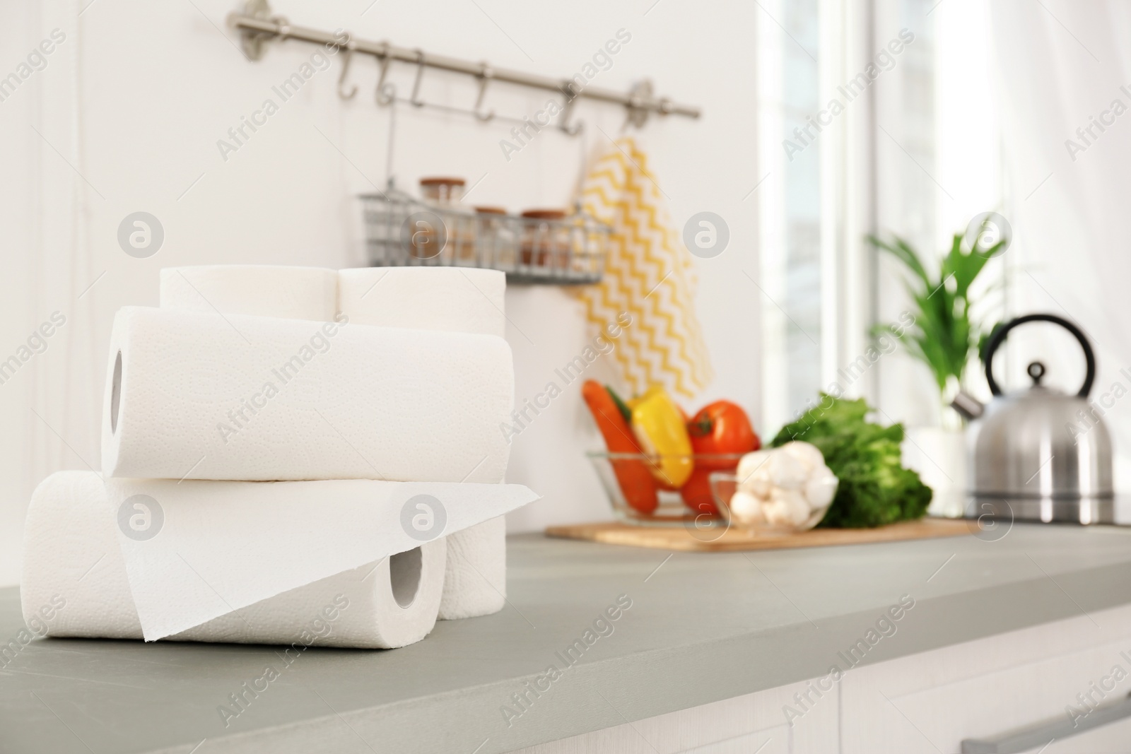 Photo of Rolls of paper towels on table in kitchen