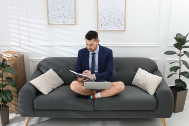 Photo of Businessman in underwear pretending to wear formal clothes during video call at home