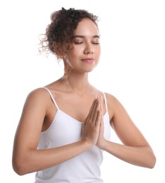Photo of Beautiful African-American woman meditating on white background