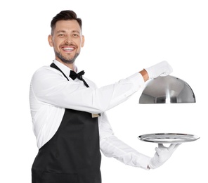 Photo of Handsome waiter holding metal tray with lid on white background