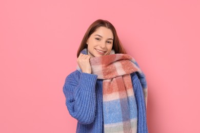 Photo of Beautiful woman in warm scarf on pink background