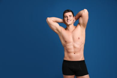 Photo of Man with sexy body on blue background