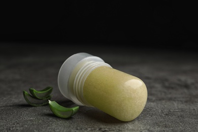 Photo of Natural crystal alum deodorant and aloe on grey table