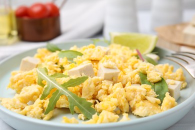 Photo of Plate with delicious scrambled eggs, tofu and lime, closeup